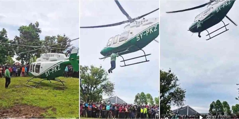 Shocking moment as man hangs onto helicopter mid-air